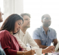 Stock image of staff attending a meeting.